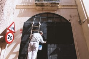 A man painting a door