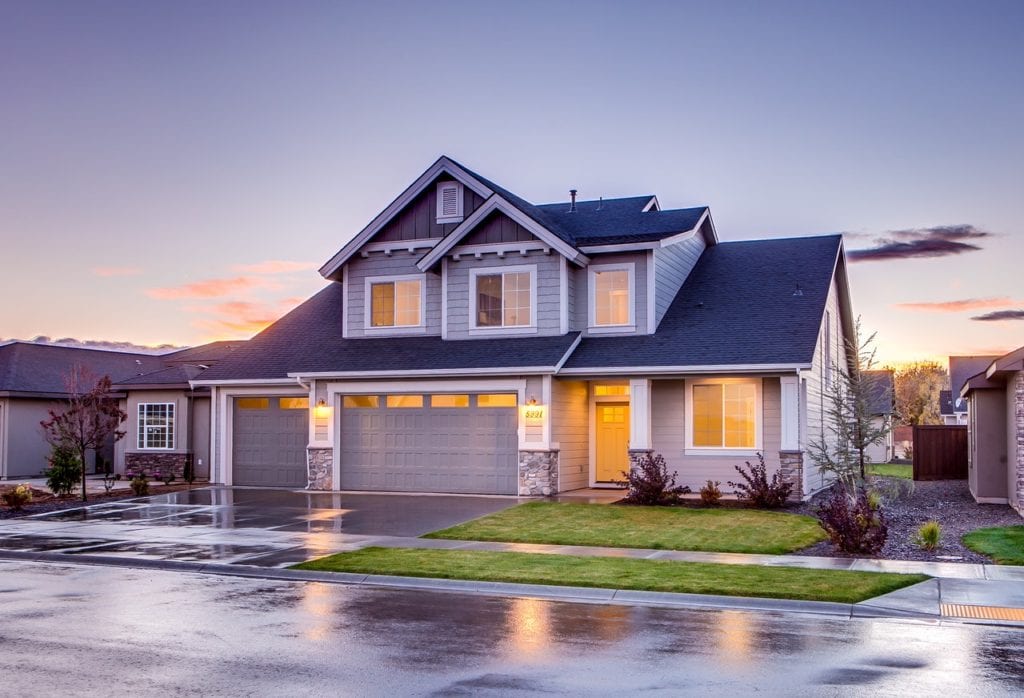 A gray house with a blue roof