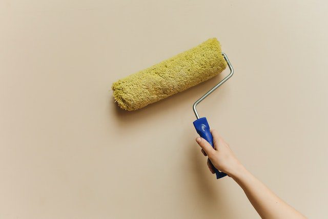 Person holding a paint roller