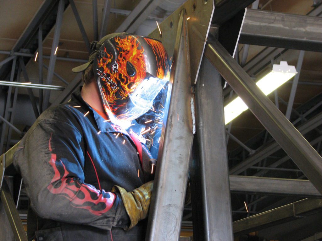 student using a welder