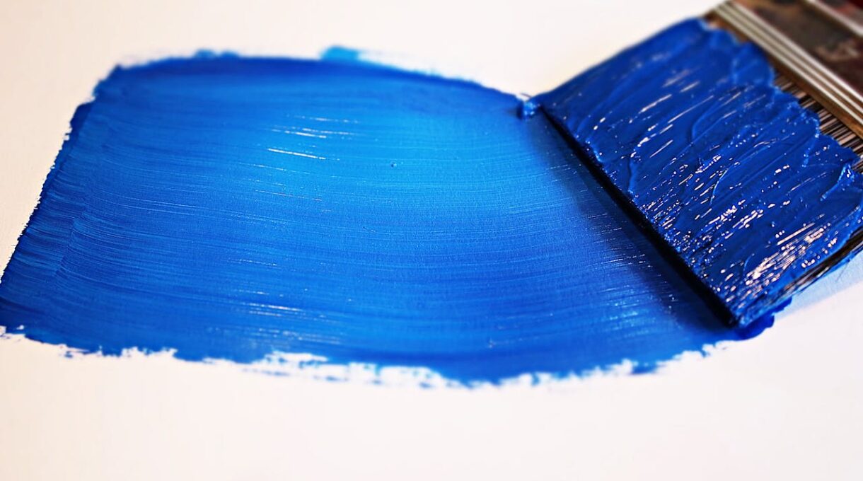 Blue paint on a white surface.